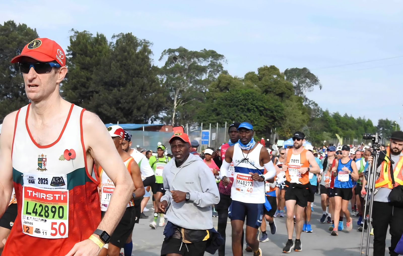 Germiston Callies runner in the white and navy vest at the Comrades Marathon 2025